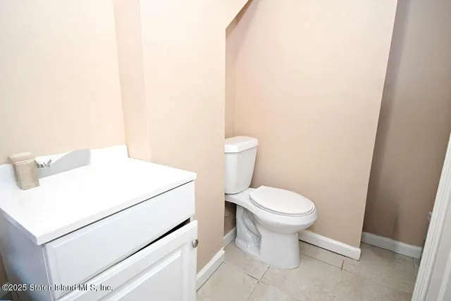 a white toilet sitting next to a white sink