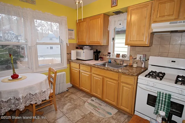 a kitchen with sink cabinets and window