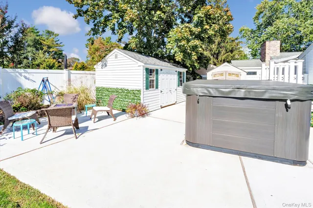 a view of a patio with table and chairs and potted plants