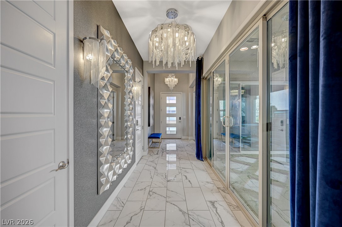 3943 Reyes Avenue Las Vegas, NV 89141 - Photo 20 of 95 Elegant entrance hallway with gleaming tiled floors and artistic lighting.