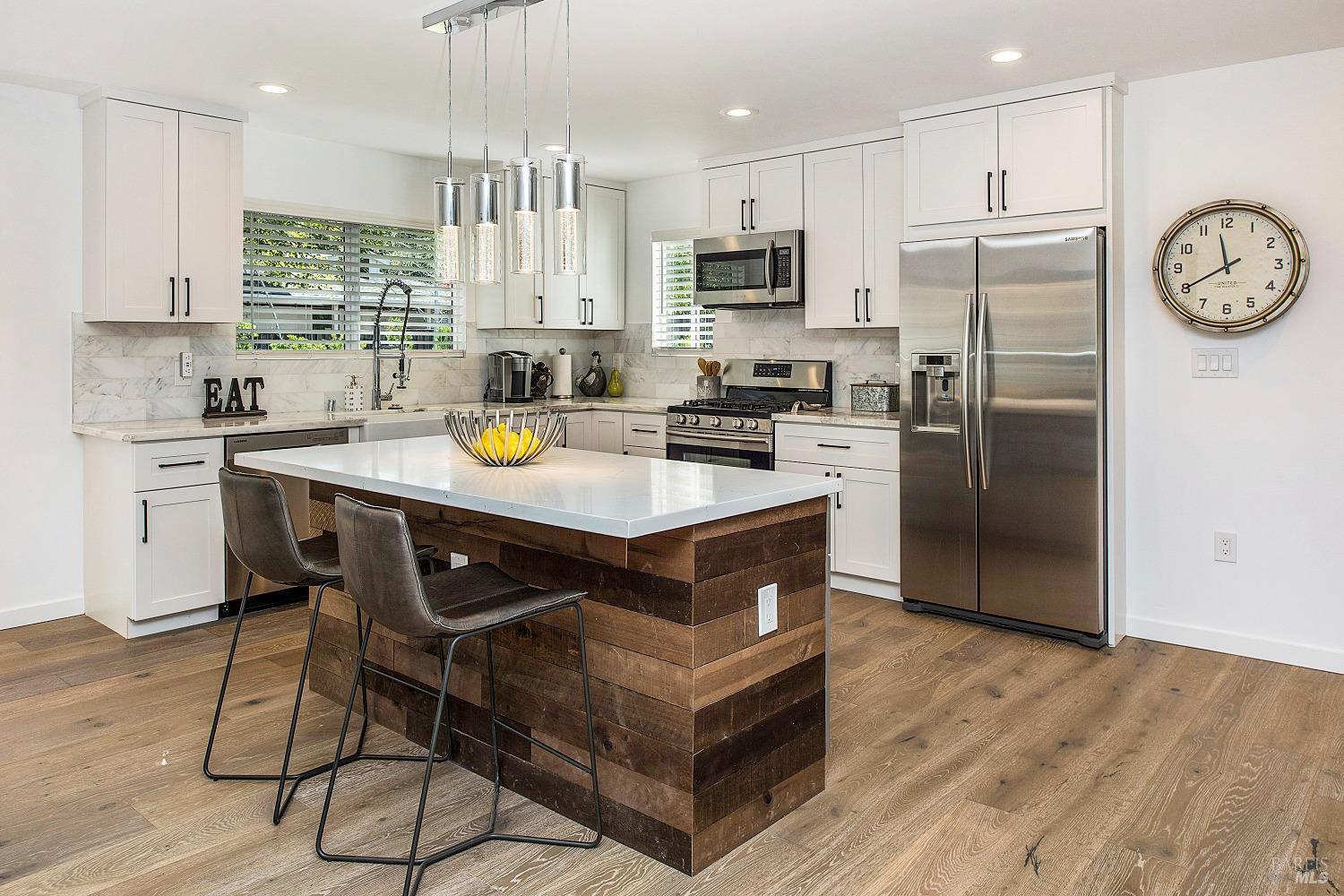 3002 Foothill Boulevard Calistoga, CA 94515 - Photo 20 of 60 a kitchen with stainless steel appliances granite countertop a stove a refrigerator a sink a stove and island with wooden floor