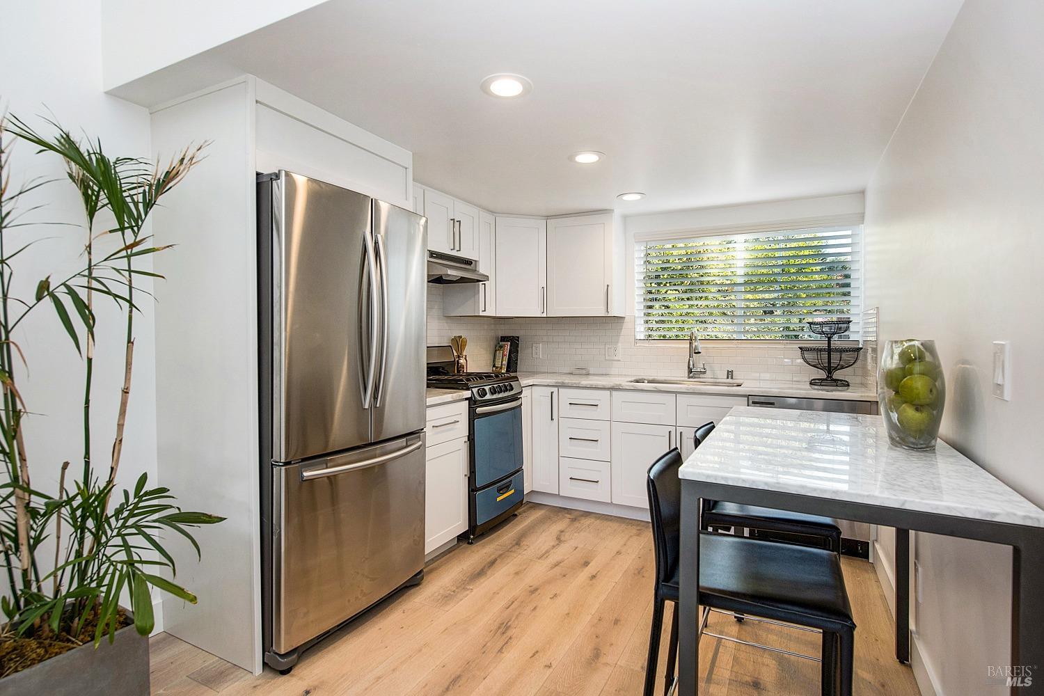 3002 Foothill Boulevard Calistoga, CA 94515 - Photo 39 of 60 a kitchen with appliances a counter space and wooden floor