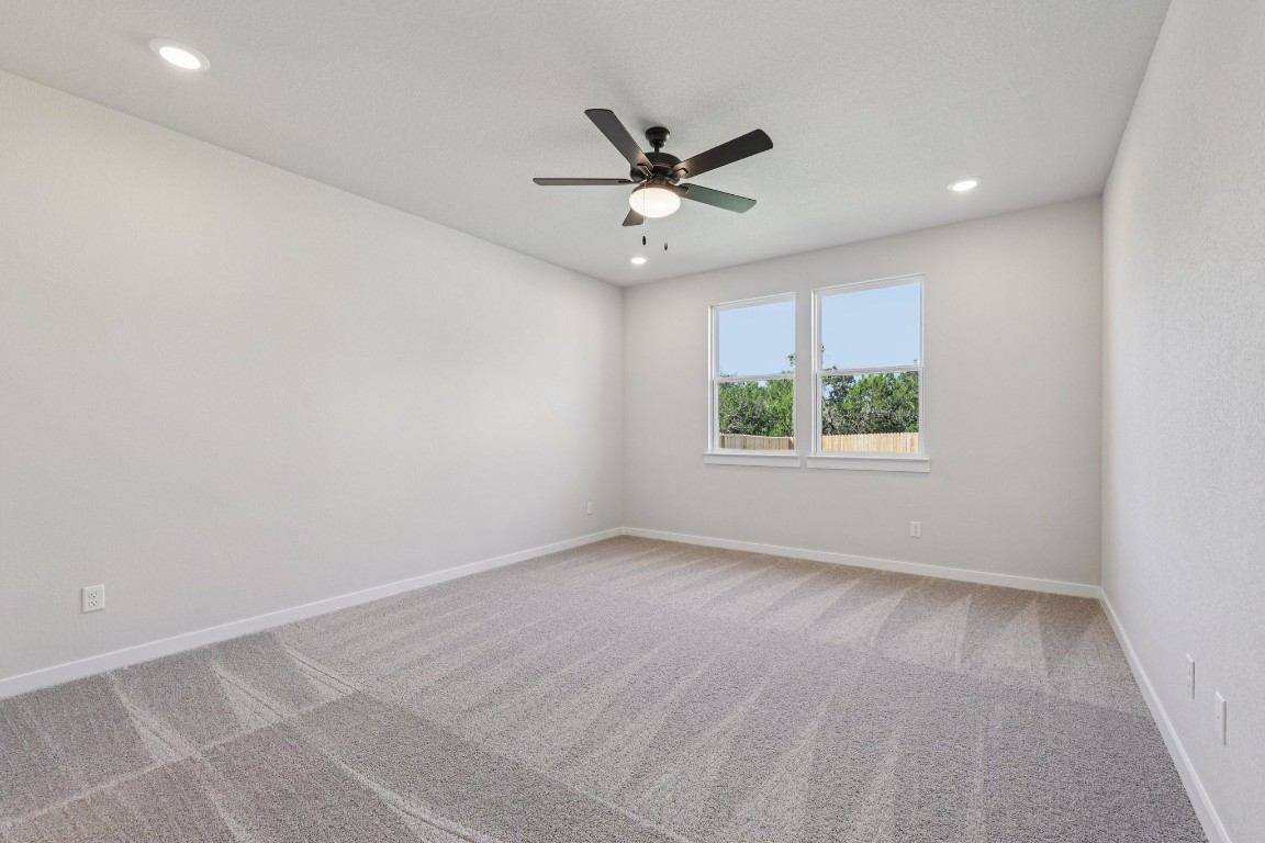 1212 Lavender Way Georgetown, TX 78628 - Photo 7 of 32 an empty room with windows and ceiling fan