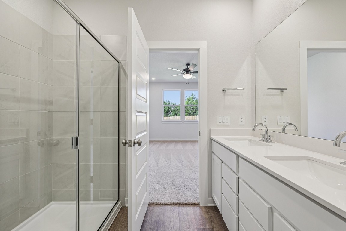 1212 Lavender Way Georgetown, TX 78628 - Photo 10 of 32 a bathroom with a granite countertop sink mirror and shower