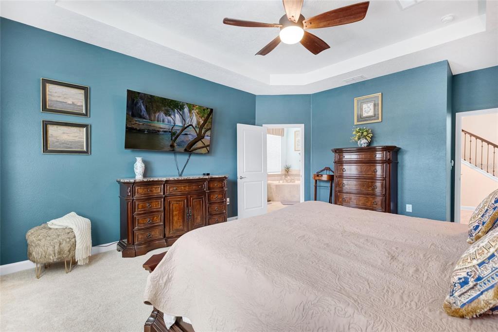 1089 Blackwolf Run Road Davenport, FL 33896 - Photo 18 of 82 a bedroom with a bed and a flat screen tv
