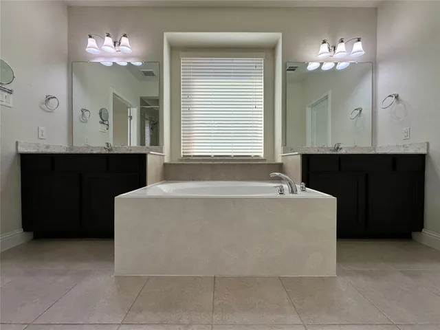a spacious bathroom with a bathtub and a sink
