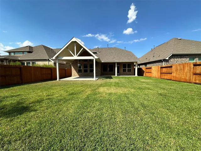 a front view of a house with yard and green space