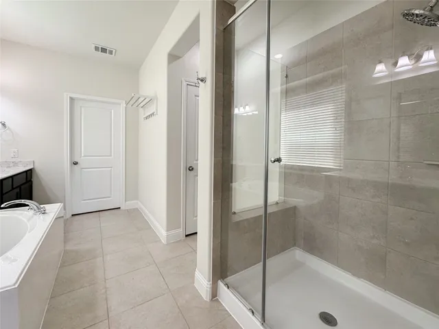 a bathroom with a bathtub and a shower