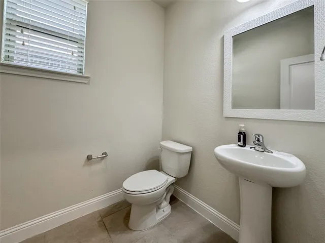a bathroom with a sink toilet and a mirror