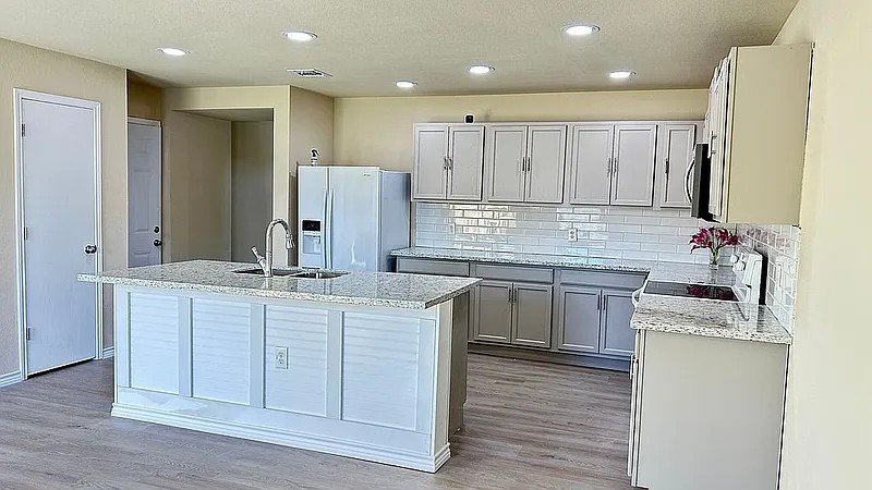 5211 Viewpoint Drive Austin, TX 78744 - Photo 8 of 25 a kitchen with stainless steel appliances granite countertop a sink stove and refrigerator