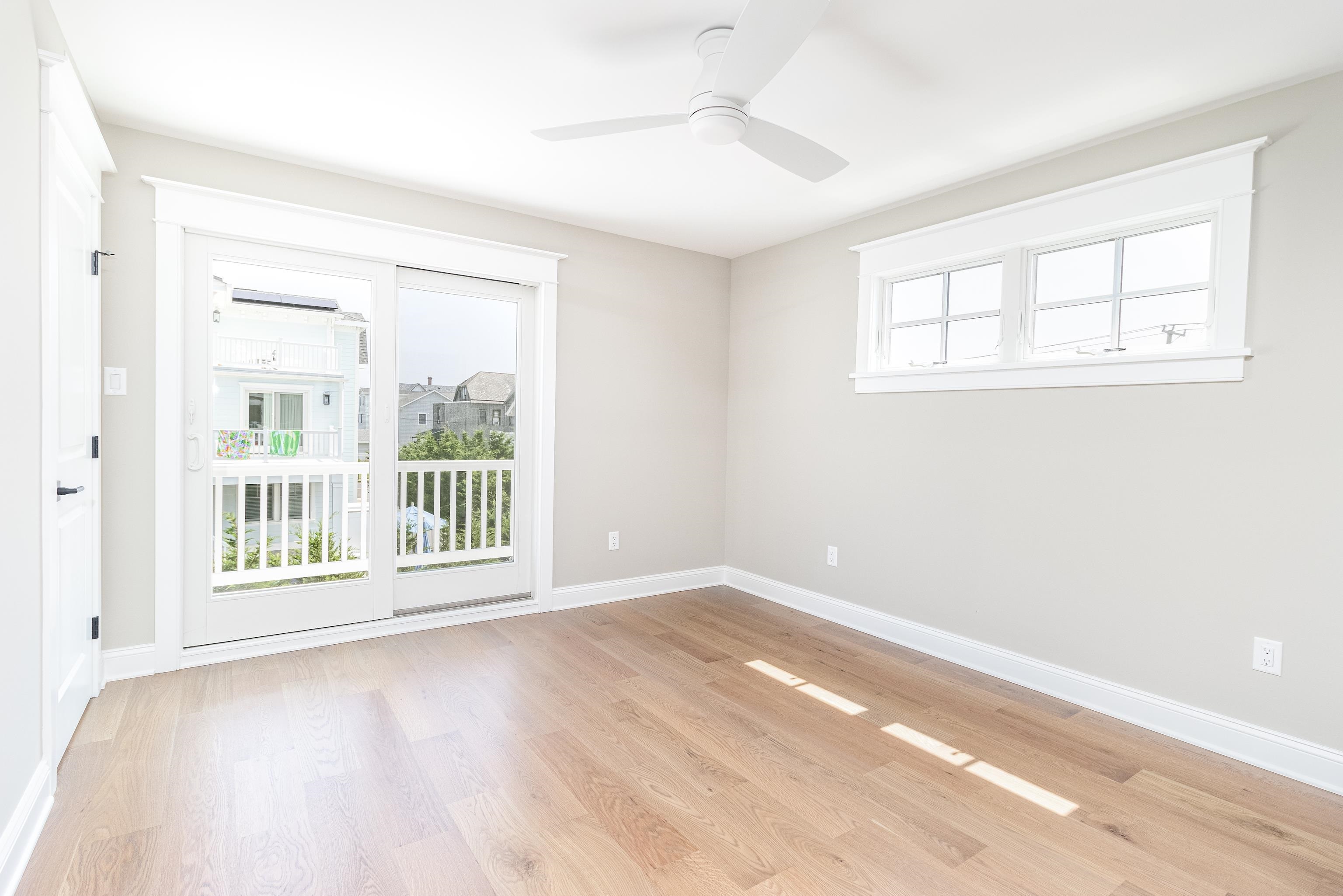 121 32nd Street Avalon, NJ 08202 - Photo 22 of 35 an empty room with wooden floor and windows