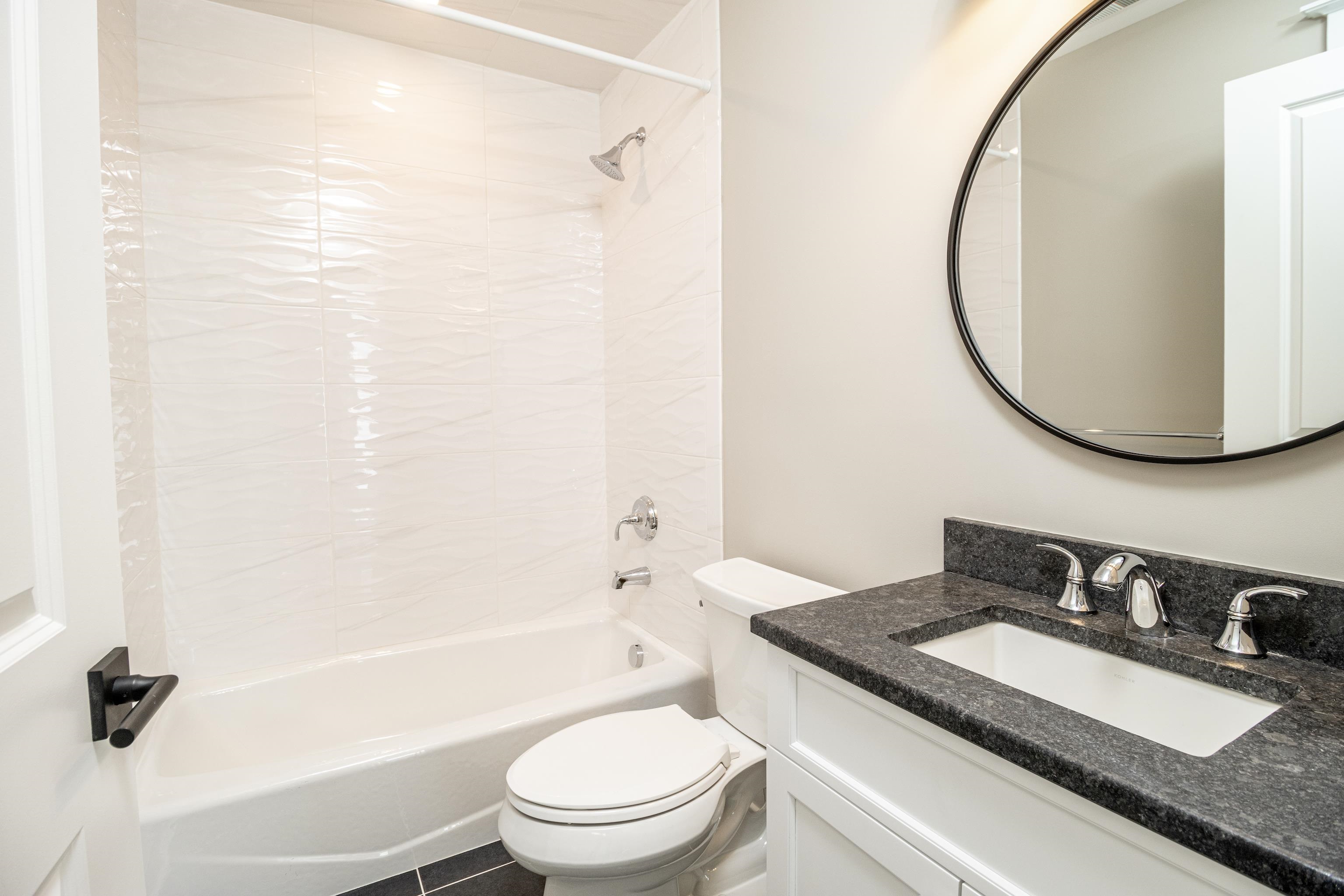 121 32nd Street Avalon, NJ 08202 - Photo 23 of 35 a bathroom with a granite countertop sink mirror toilet and bathtub
