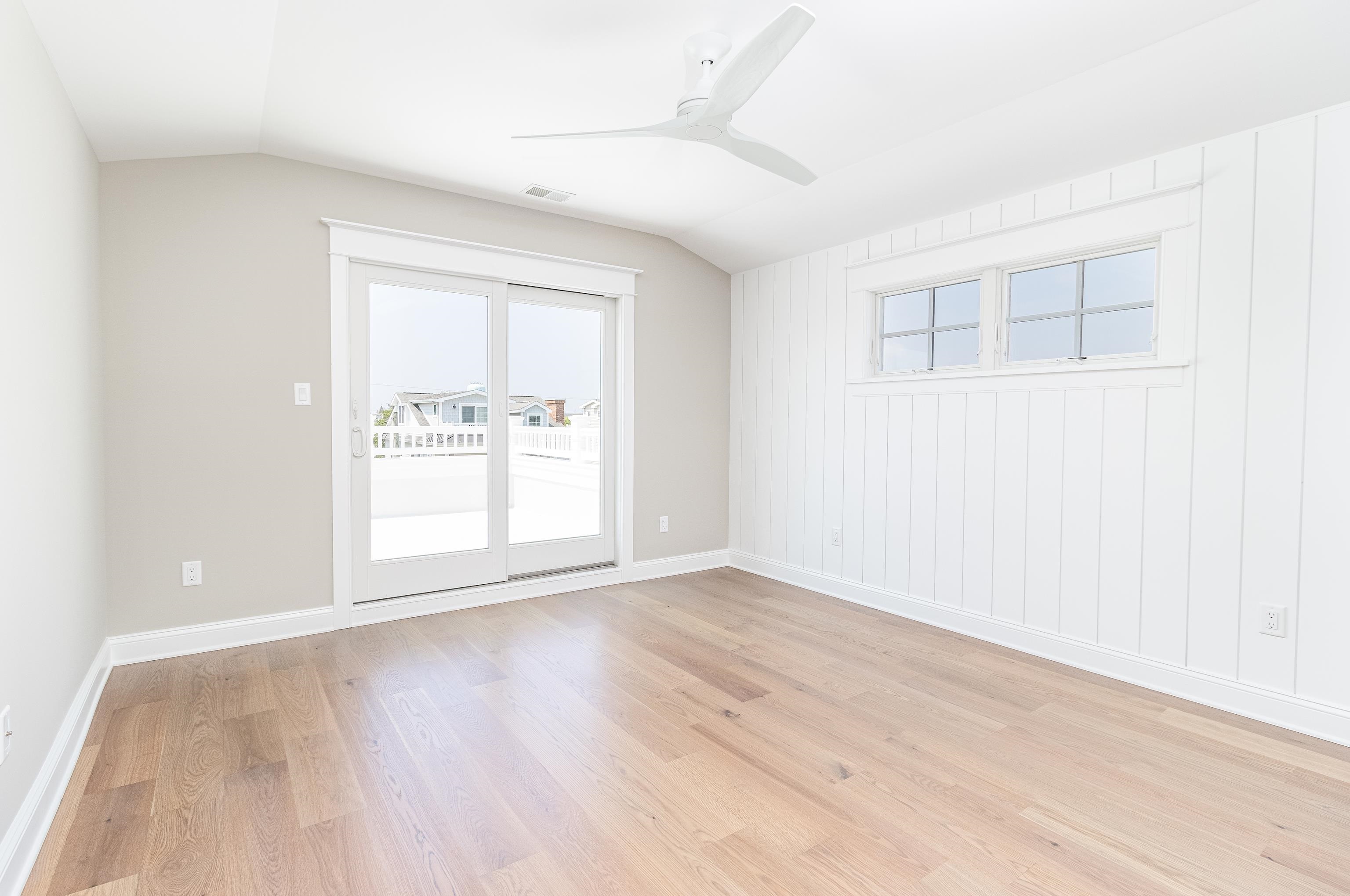 121 32nd Street Avalon, NJ 08202 - Photo 26 of 35 an empty room with wooden floor and windows