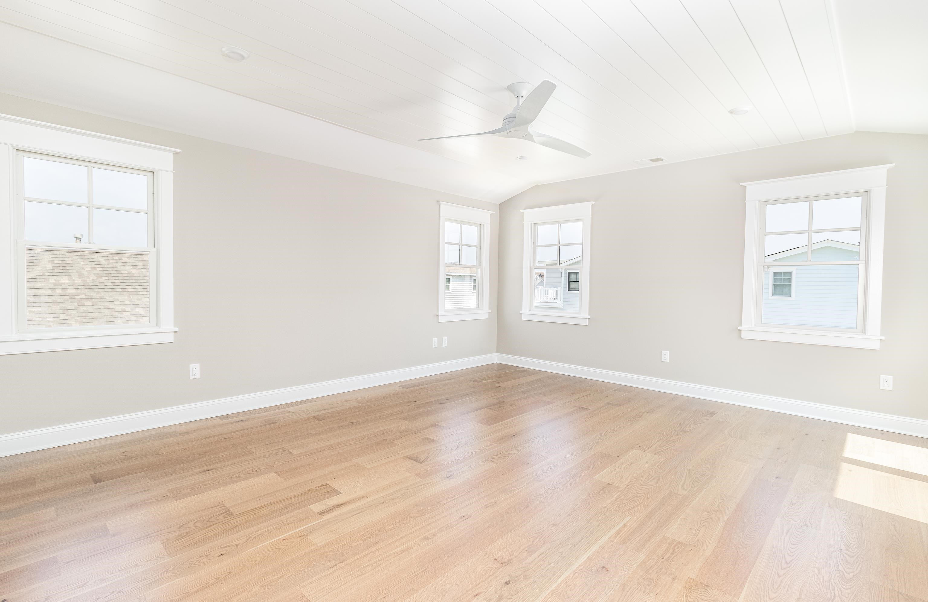 121 32nd Street Avalon, NJ 08202 - Photo 29 of 35 an empty room with wooden floor and windows