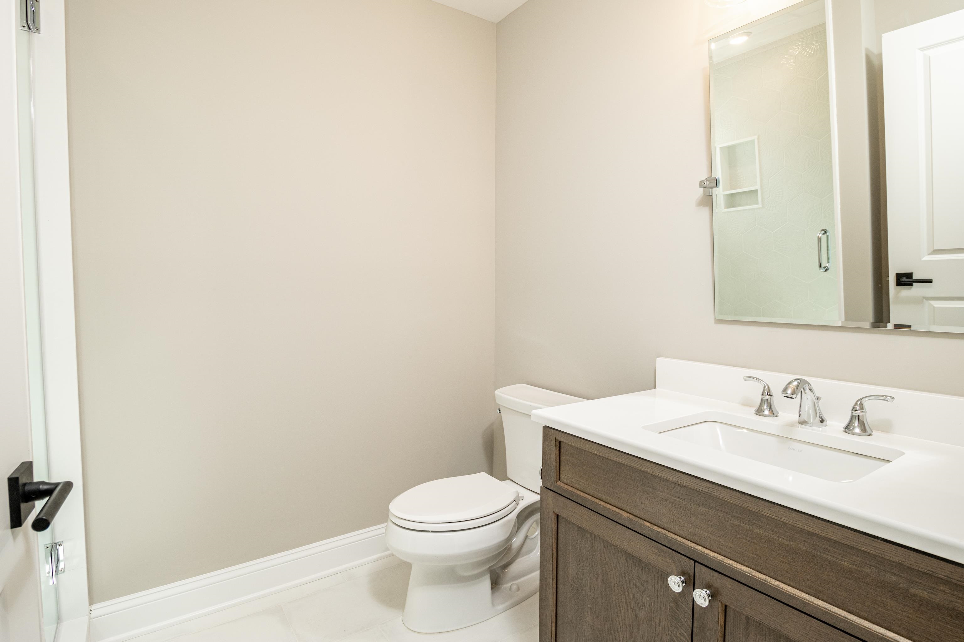121 32nd Street Avalon, NJ 08202 - Photo 9 of 35 a bathroom with a sink a toilet and mirror