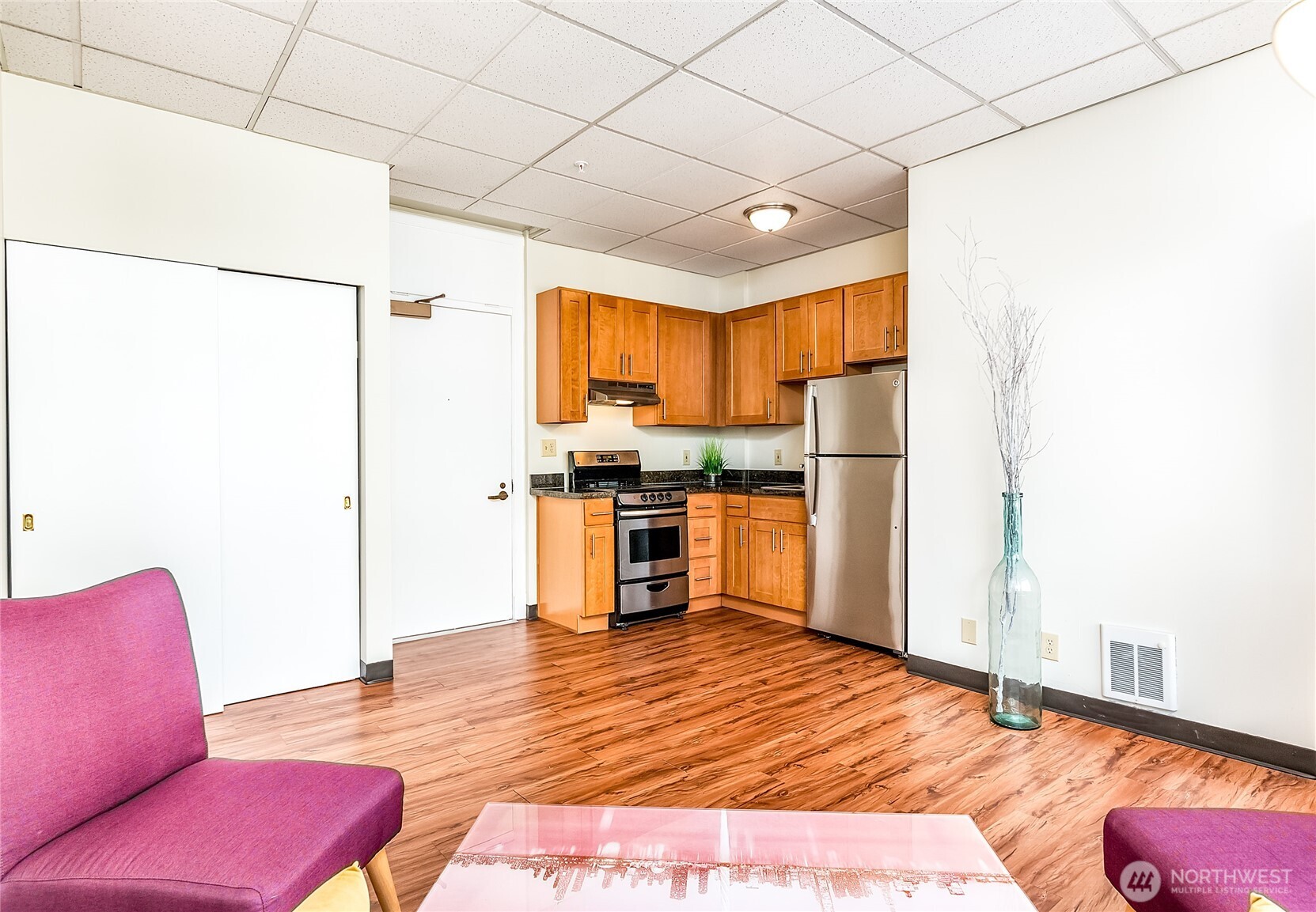 523 Pine Street, Unit 1005 Seattle, WA 98101 - Photo 6 of 10 a kitchen with stainless steel appliances a refrigerator and a stove top oven