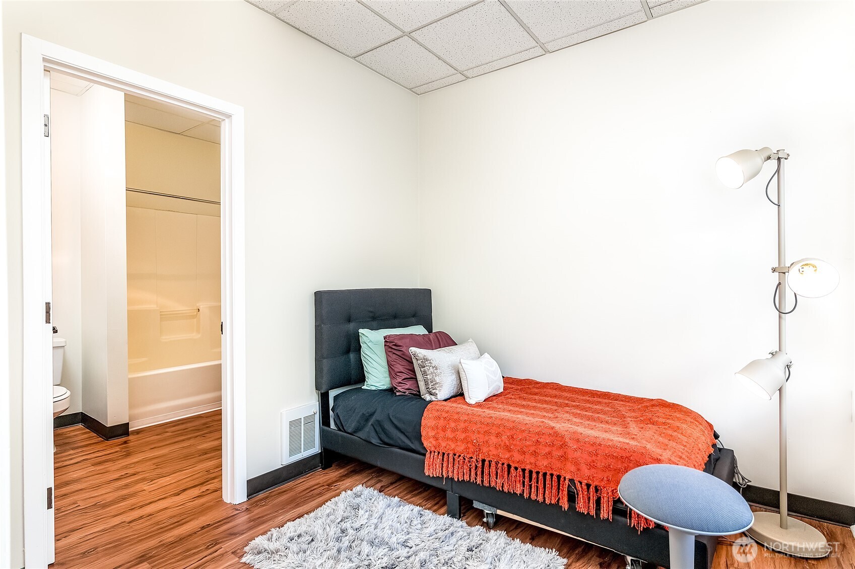 523 Pine Street, Unit 1005 Seattle, WA 98101 - Photo 9 of 10 a bedroom with a bed and wooden floor