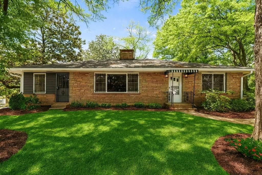 a front view of house with yard and green space