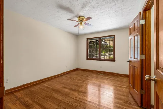 wooden floor in an empty room with a window