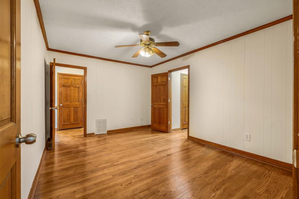 1930 Hollywood Road Northwest Atlanta, GA 30318 - Photo 16 of 19 an empty room with wooden floor chandelier fan and windows