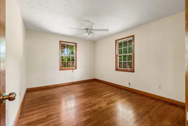 wooden floor in an empty room with a window