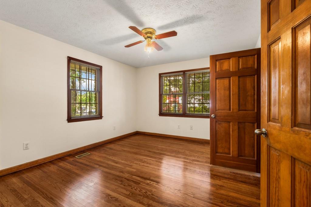 1930 Hollywood Road Northwest Atlanta, GA 30318 - Photo 19 of 19 an empty room with wooden floor fan and windows