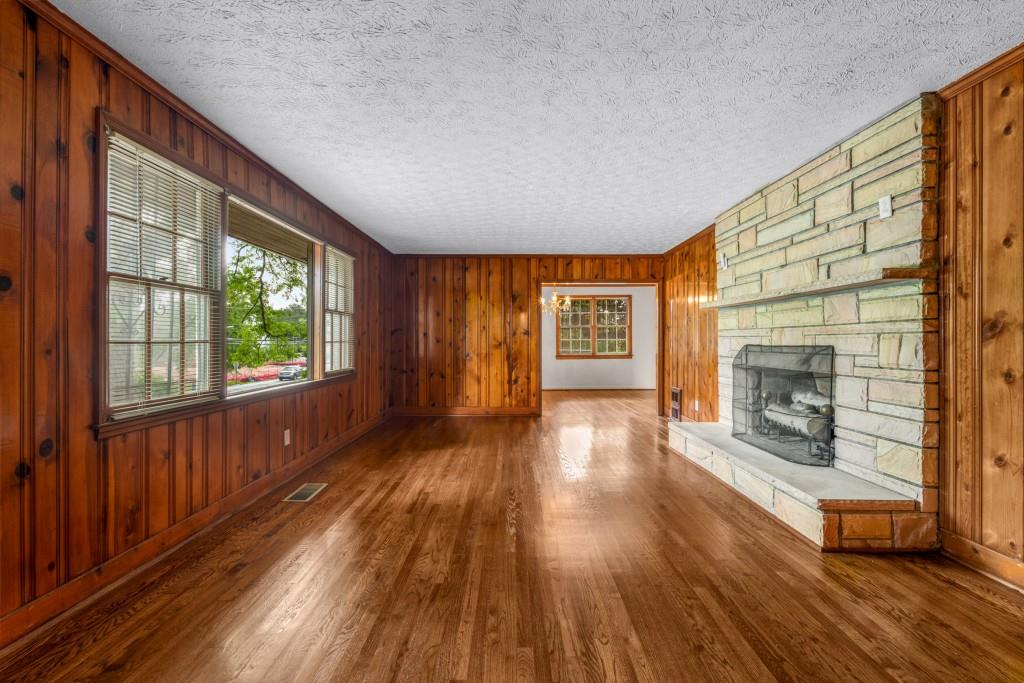 1930 Hollywood Road Northwest Atlanta, GA 30318 - Photo 4 of 19 a view of a room with wooden floor fireplace and windows