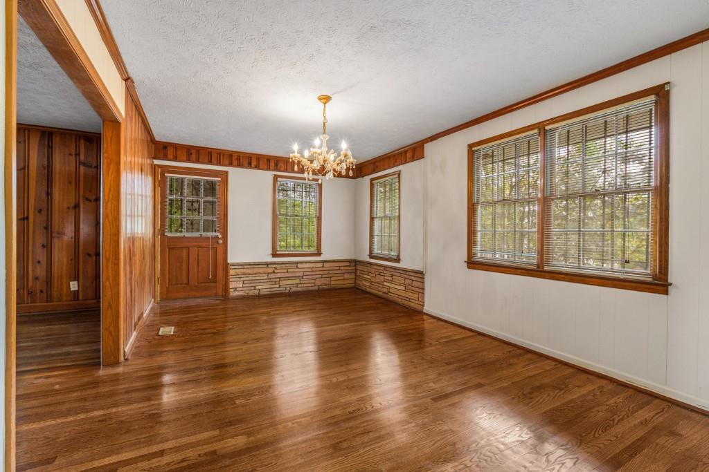 1930 Hollywood Road Northwest Atlanta, GA 30318 - Photo 6 of 19 a view of an empty room with wooden floor and a window