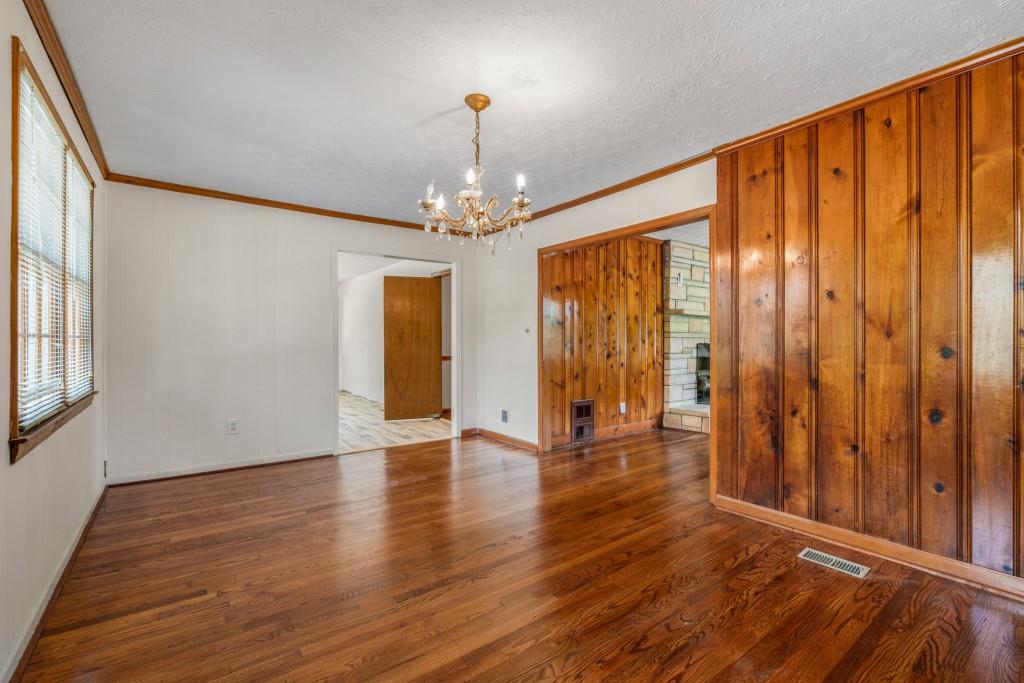 1930 Hollywood Road Northwest Atlanta, GA 30318 - Photo 7 of 19 a view of an empty room with wooden floor and a window