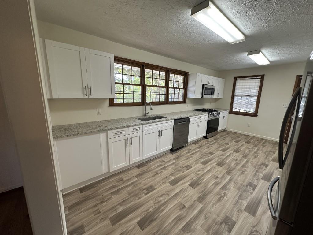 1930 Hollywood Road Northwest Atlanta, GA 30318 - Photo 8 of 19 a kitchen with a sink stove and cabinets