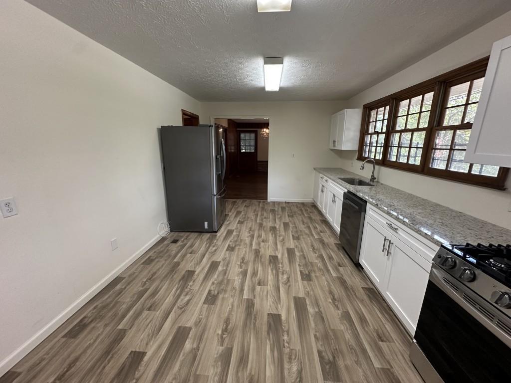 1930 Hollywood Road Northwest Atlanta, GA 30318 - Photo 9 of 19 a kitchen with a sink and wooden floor