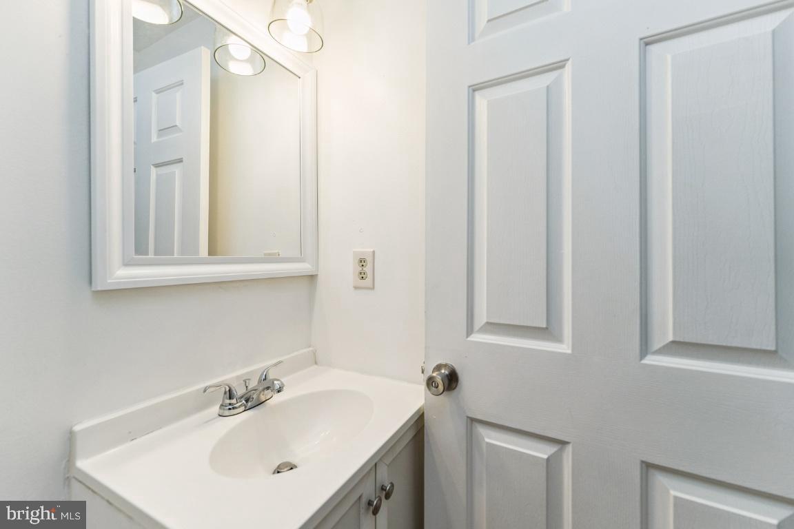 8106 Triple Crown Road Bowie, MD 20715 - Photo 11 of 26 a bathroom with a sink and a mirror