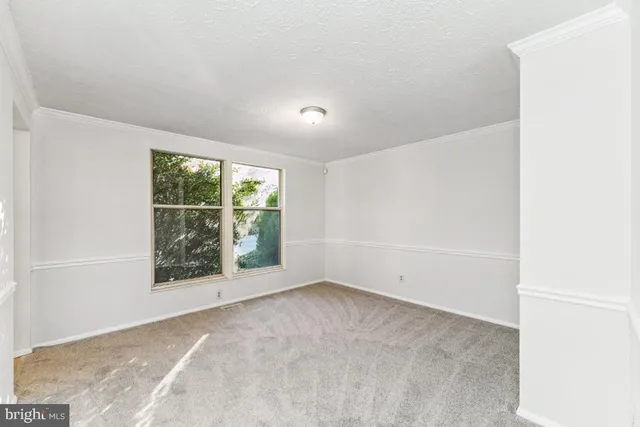 a dining room with wooden floor and a chandelier