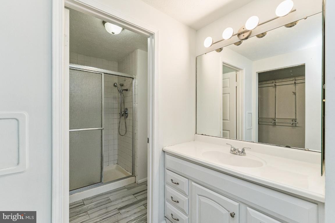 8106 Triple Crown Road Bowie, MD 20715 - Photo 17 of 26 a bathroom with a shower sink and mirror