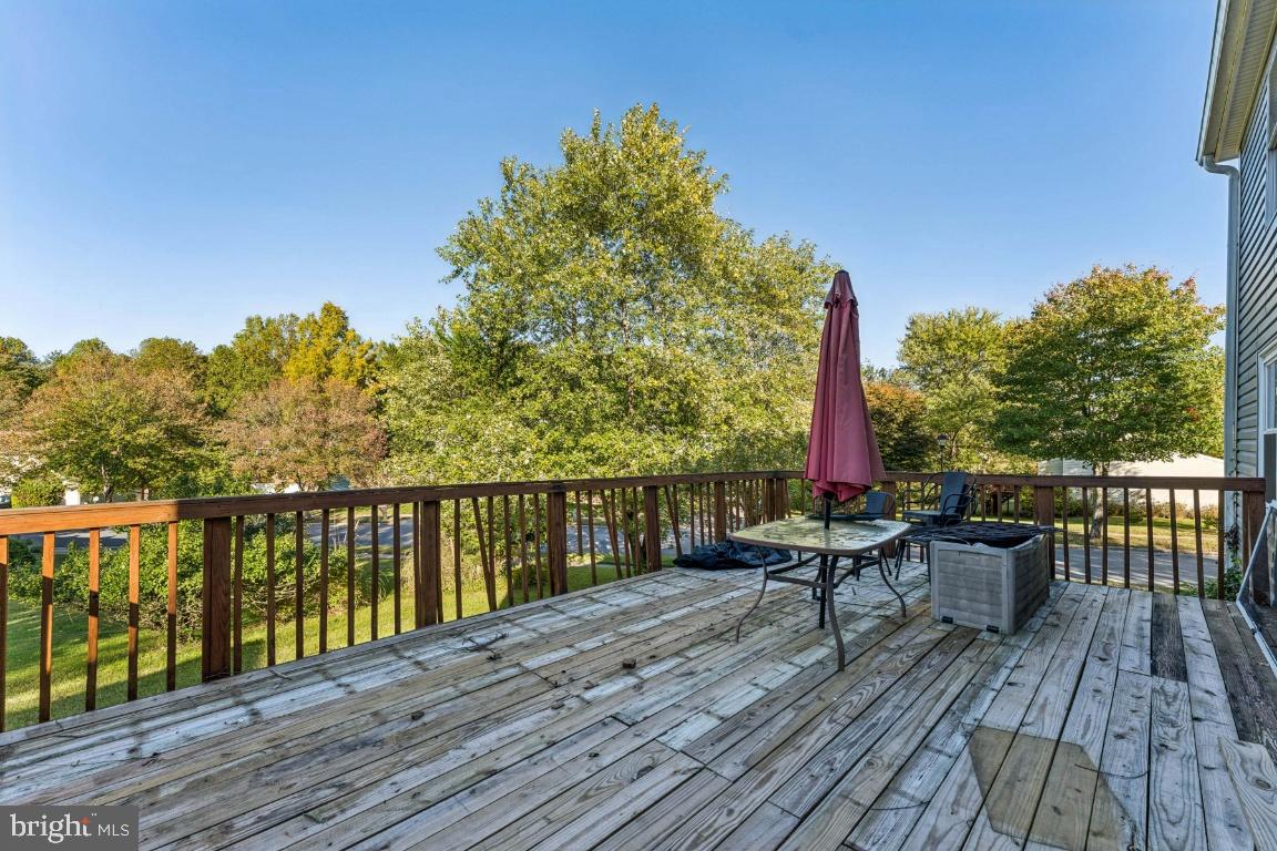 8106 Triple Crown Road Bowie, MD 20715 - Photo 22 of 26 a view of a balcony with wooden floor and outdoor seating