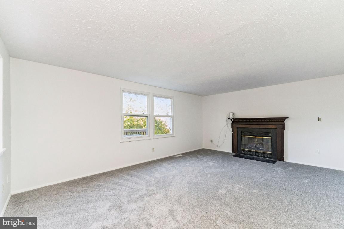 8106 Triple Crown Road Bowie, MD 20715 - Photo 5 of 26 an empty room with windows and fireplace