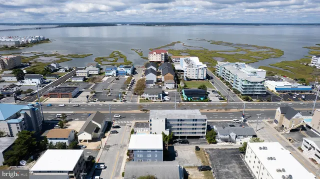 a view of swimming pool with outdoor seating space and lake view