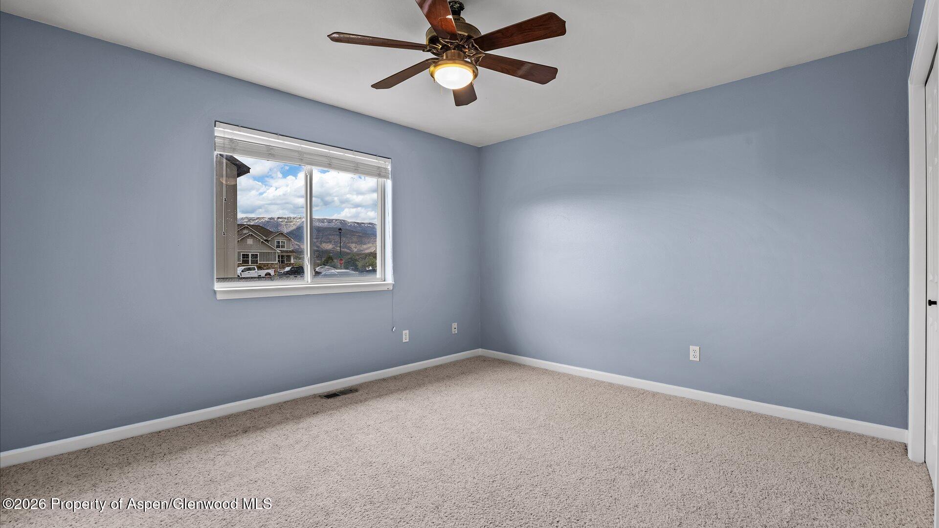 1459 Anvil View Avenue Rifle, CO 81650 - Photo 18 of 29 an empty room with a window and a fan