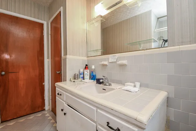 a bathroom with a sink and a mirror