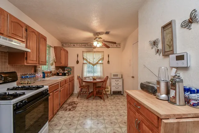 a kitchen with a stove a sink and a refrigerator