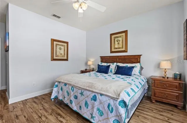 a bedroom with bed and painting on the wall