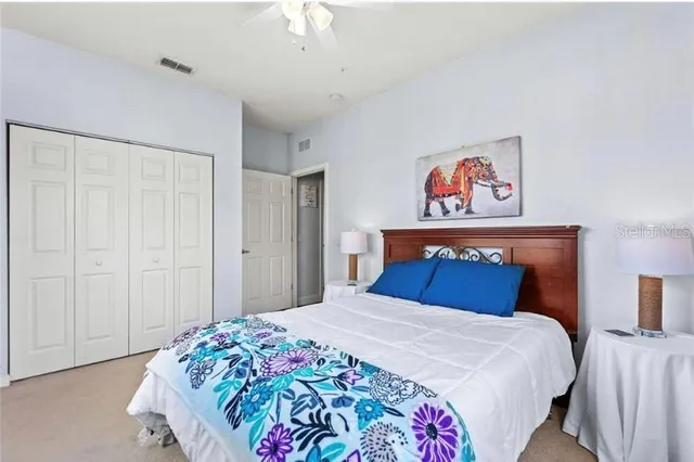 a bedroom with a bed and a painting on the wall