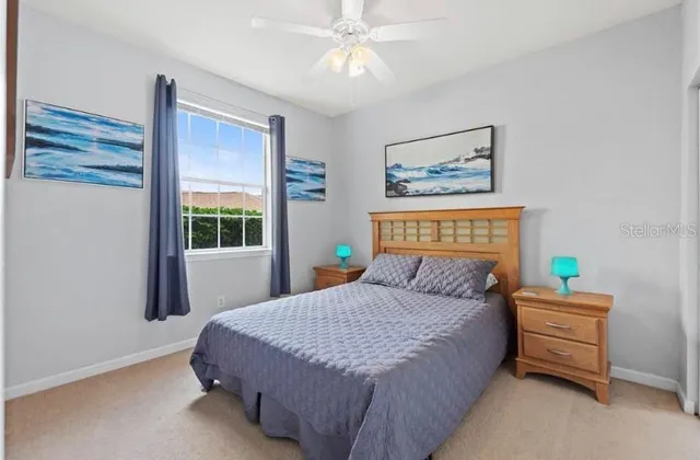 a bedroom with a bed dresser and a window