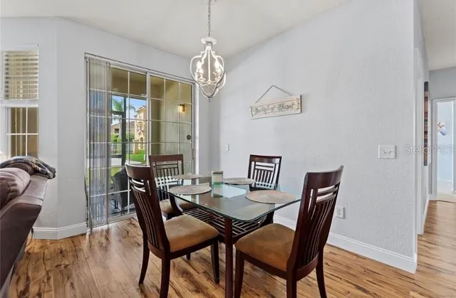 a view of a dining room with furniture wooden floor and chandelier