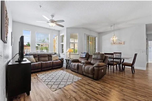 a living room with furniture wooden floor and a chandelier