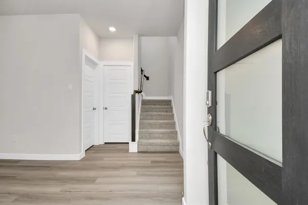 a view of an entryway with wooden floor