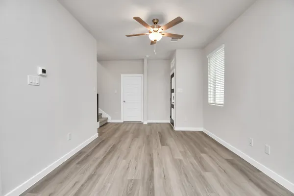 wooden floor in an empty room with a window