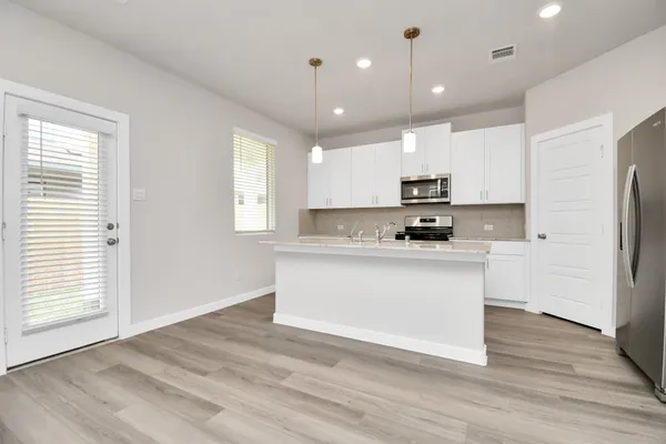 a kitchen with a refrigerator window and a stove