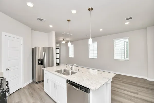 a kitchen with a sink a refrigerator and window