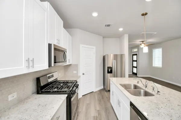 a kitchen with a sink stove and refrigerator